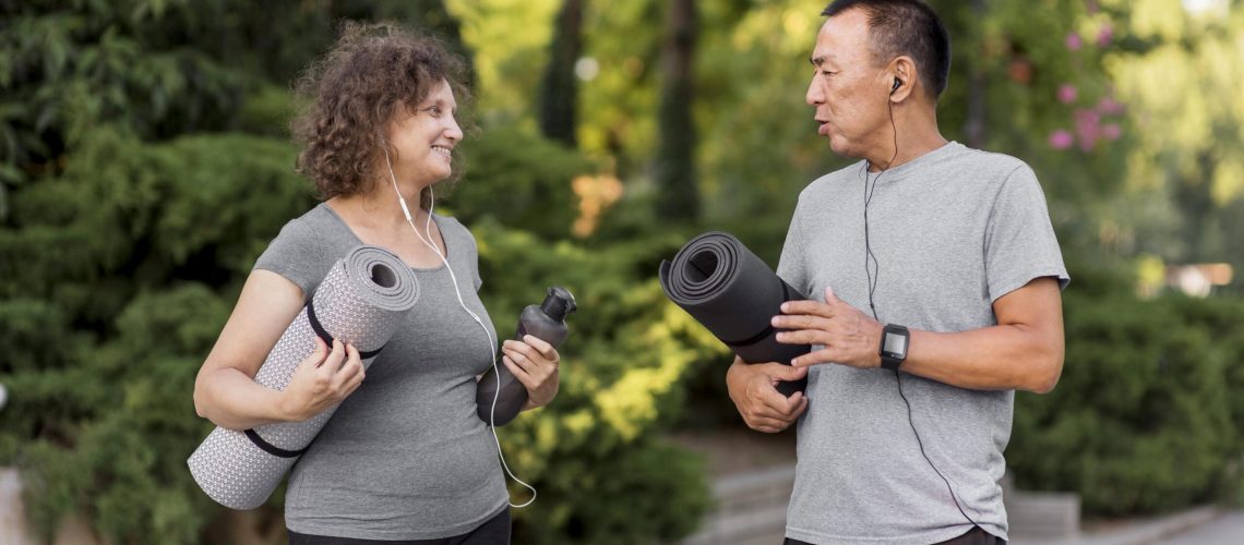 medium-shot-adult-holding-yoga-mats-min